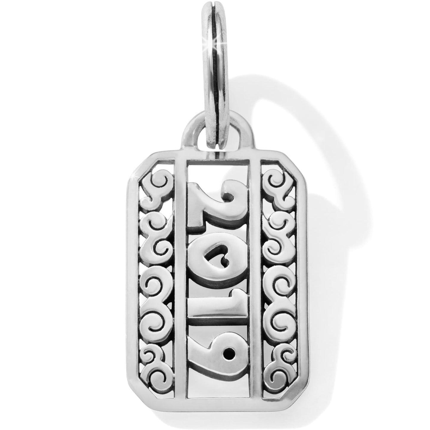 Brighton 2019 charm with silver-plated scrollwork detail and split ring on a white background
