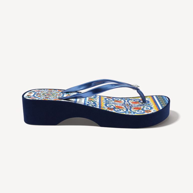 Side view of a blue flip flop with an Italian print
