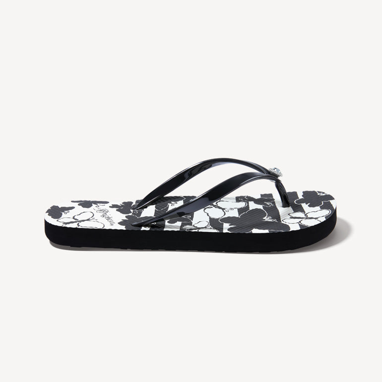 Side view of a flip flop with a black and white butterfly pattern
