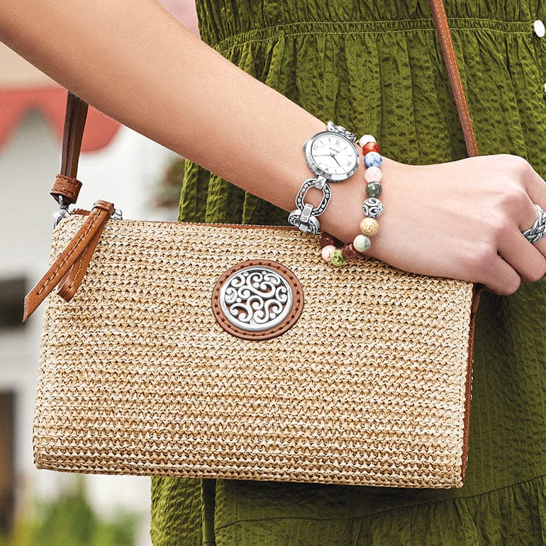 Close-up of a model wearing a straw bag