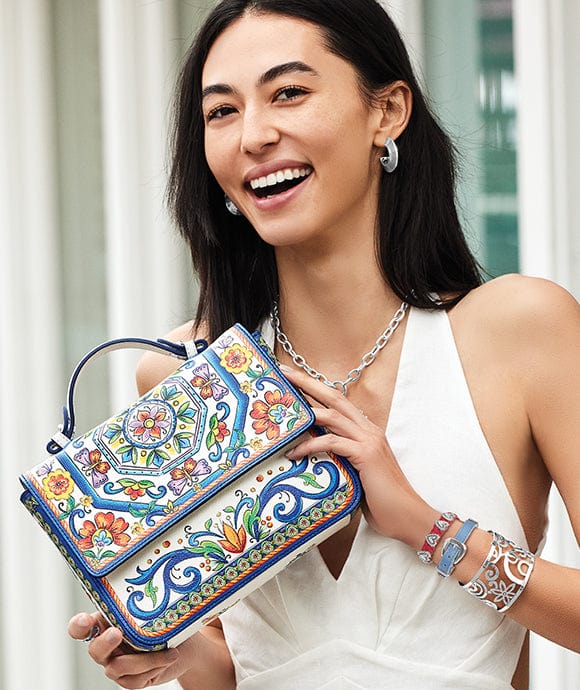 A model holding a La Farfalla handbag