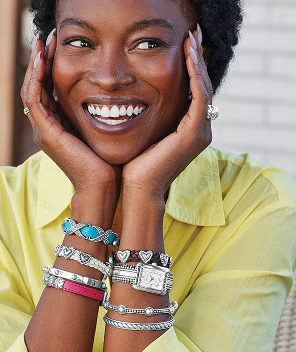 A model wearing bandits, bracelets, and a watch