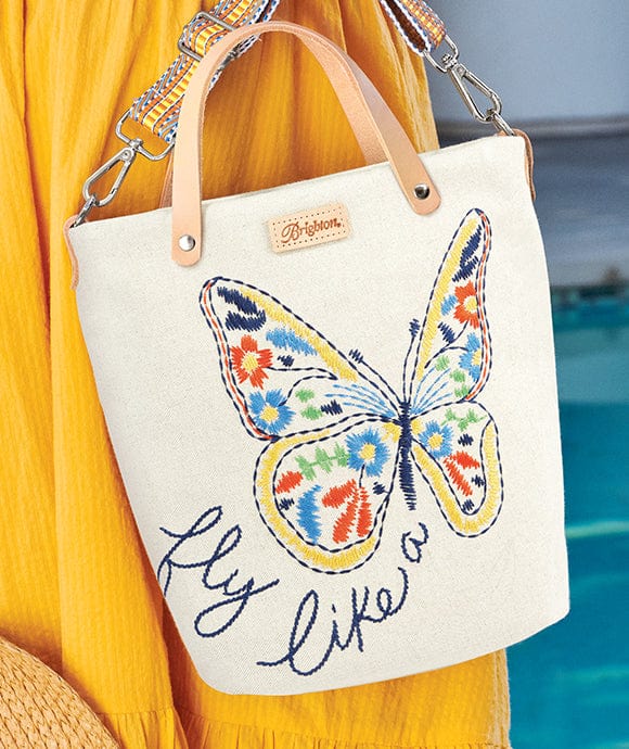 A model holding an artful tote