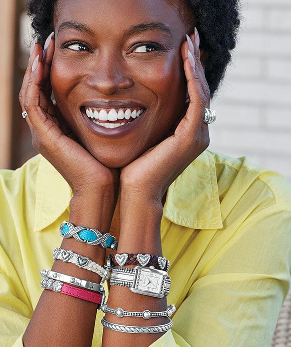 A model wearing stacks of bandits, bracelets, and a watch