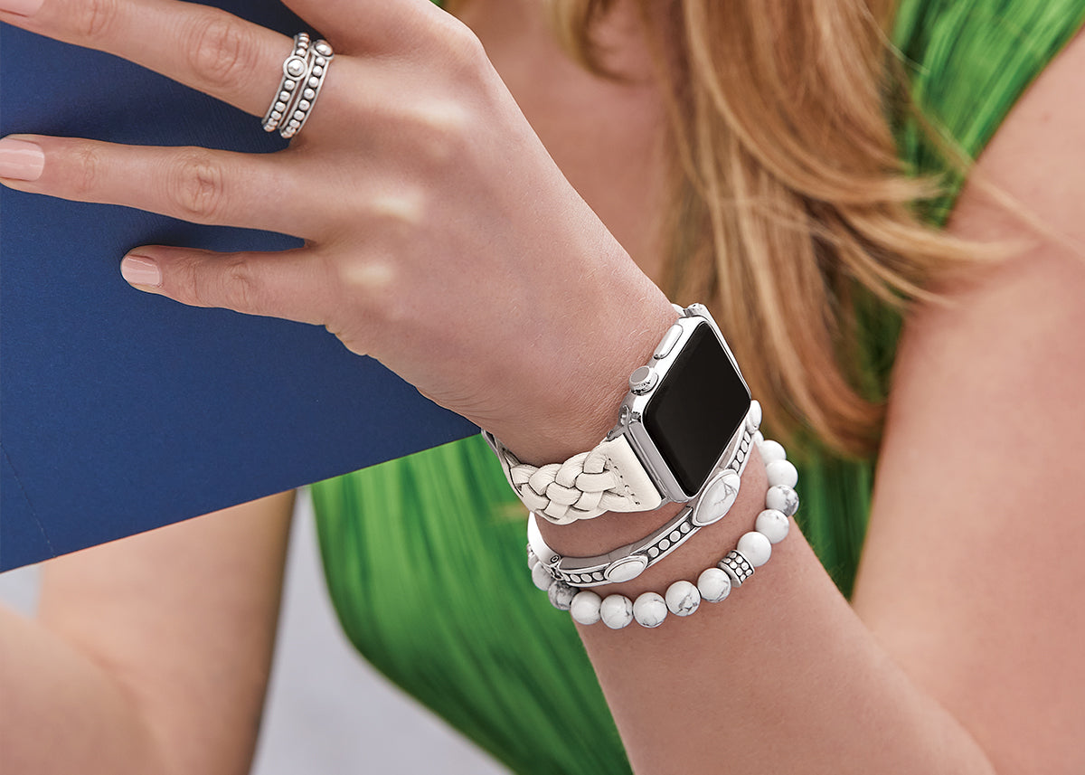 Model wearing white watch band with white bracelets