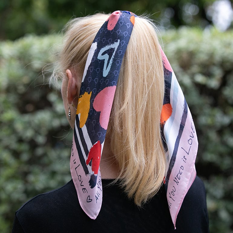 A woman with a scarf tied on her ponytail