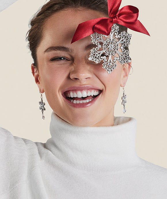 model holding a snowflake ornament