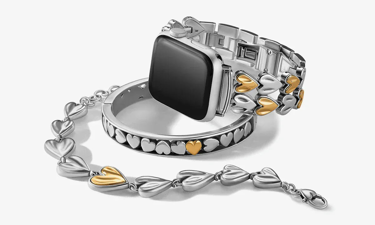 Silver and gold watch Brighton band with heart designs on a white background