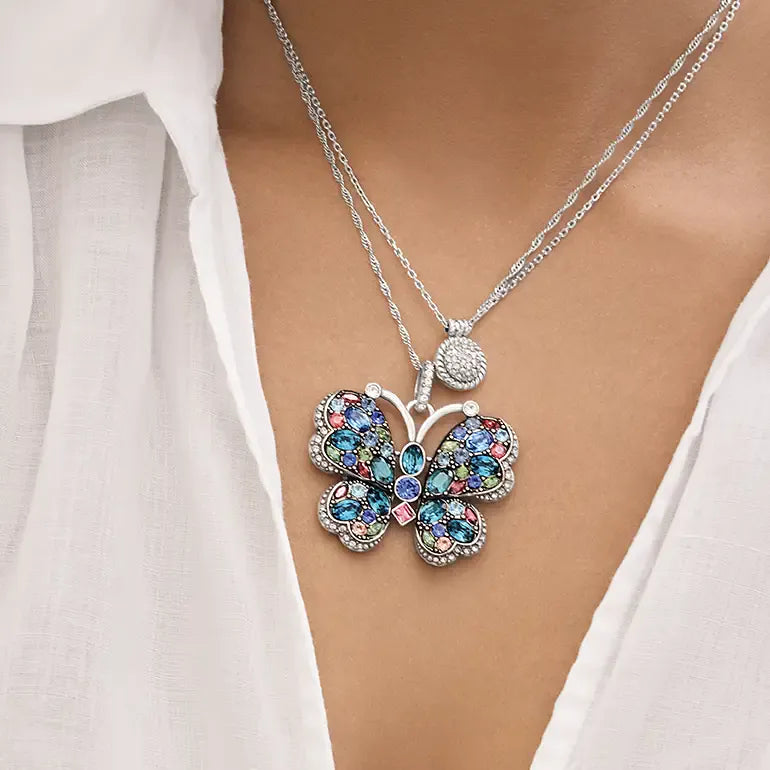 Brighton Butterfly-shaped necklace with colorful gemstones on a white shirt