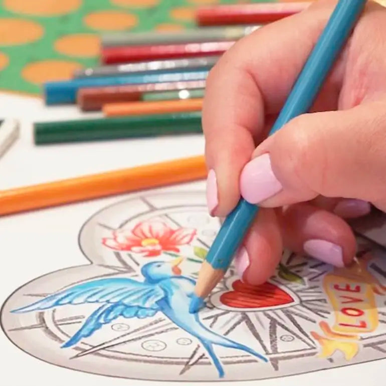 Hand coloring a picture of a blue bird with a blue pencil on a coloring book page.