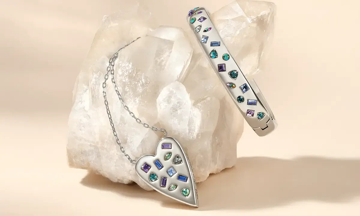 Jewelry set with heart-shaped pendant and bracelet on a stone background
