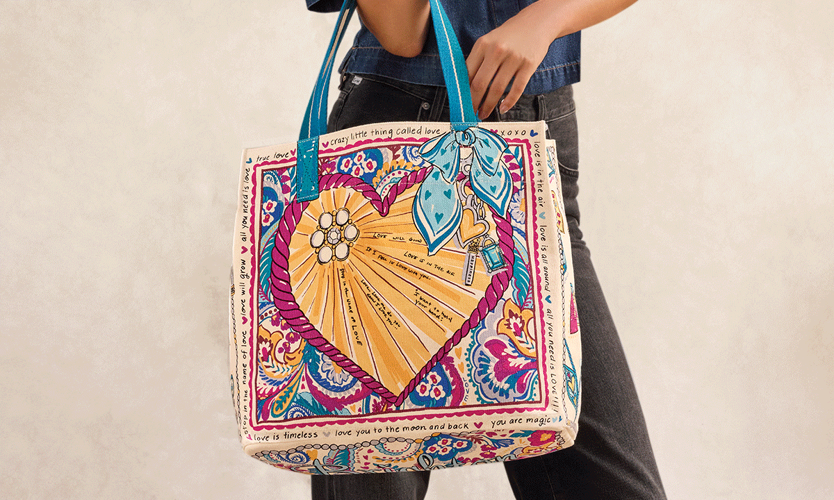 An alternating animation of a model holding a canvas tote bag with a bright graphic on the front. It alternates to the back side of the bag.
