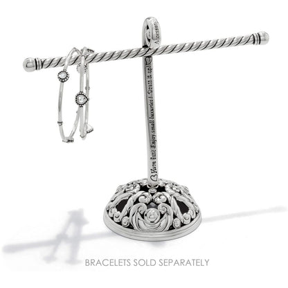 Brighton silver-plated jewelry stand with ornate scrolled base and engraved script text, displaying bangles on a white background