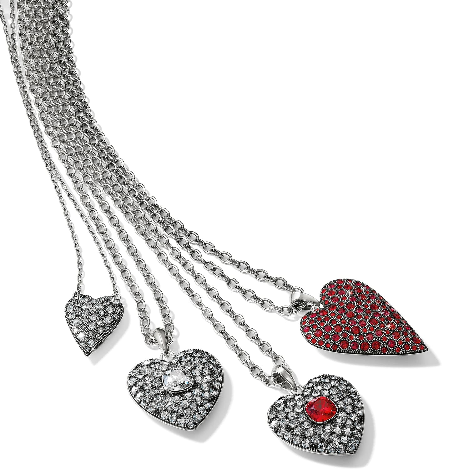 Brighton heart pendant necklaces with silver-plated chains and clear and red crystal pave hearts on a white background