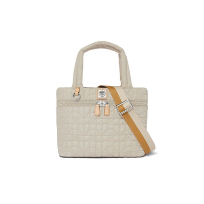 Brighton quilted handbag in cream with heart pattern, dual top handles, and tan adjustable crossbody strap on a white background