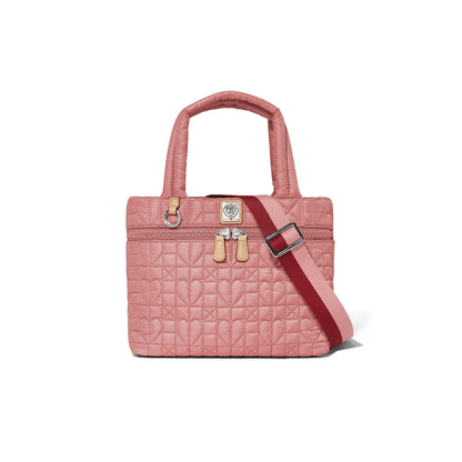 Brighton handbag in pink quilted heart pattern with dual top handles and red striped crossbody strap on a white background