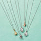 Brighton silver-plated chain necklaces styled with assorted seashell pendants in gold, silver, and rose gold tones