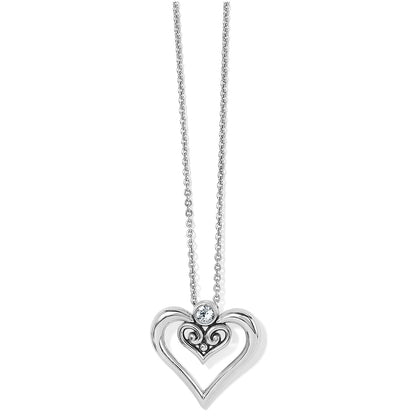 Brighton pendant necklace with silver-plated open heart, scroll filigree center, and crystal accent on a white background