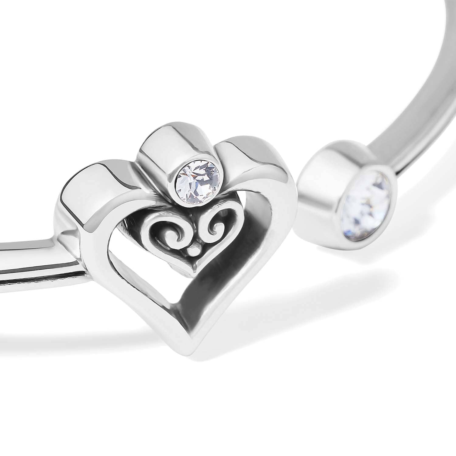 Close-up of Brighton silver-plated bracelet with open heart scroll motif and clear crystal accents at ends