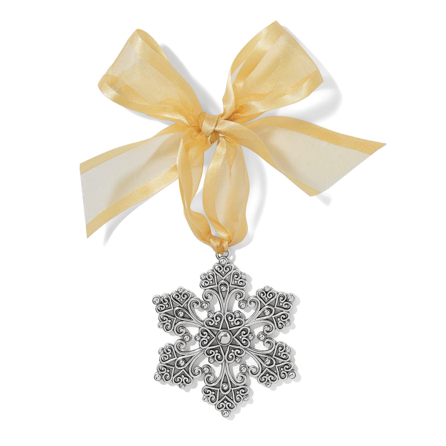 Brighton snowflake ornament with silver-plated filigree scrollwork design and gold organza ribbon bow on a white background