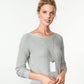 Model wearing a Brighton long silver-plated pendant necklace with rectangular white pendant and small crystal accent