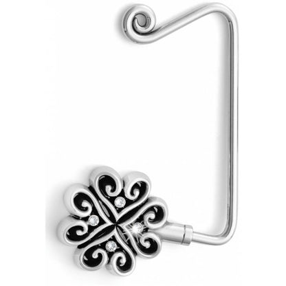 Brighton purse hook with silver-tone scrolled floral medallion and crystal accents on a white background