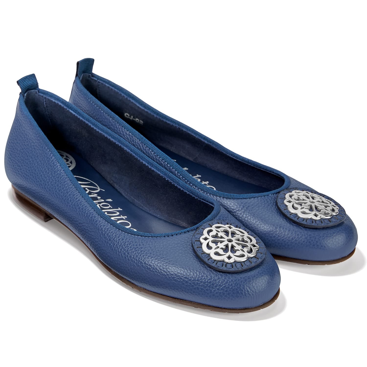 Brighton blue leather ballet flats with silver-tone medallion ornament at the round toe on a white background