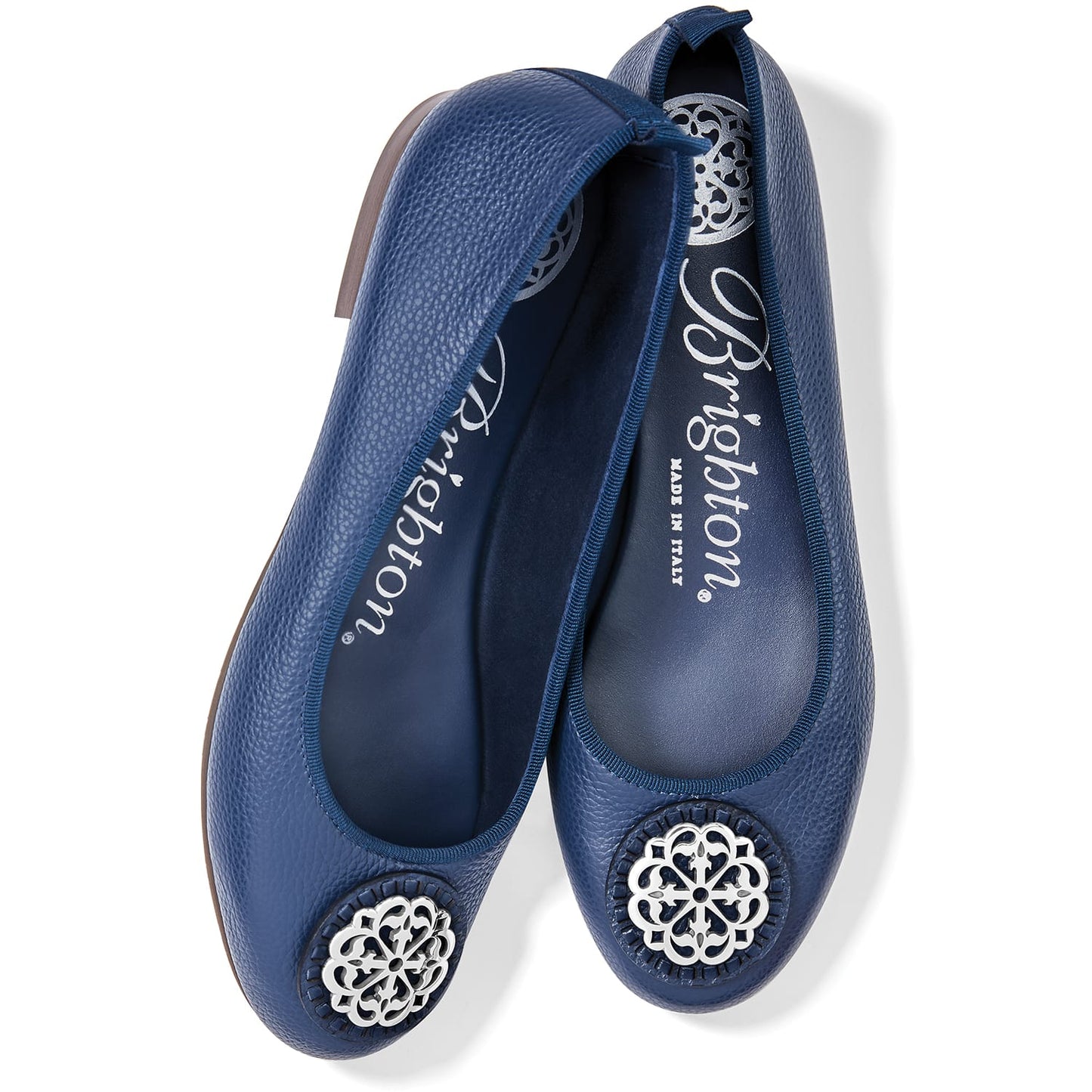 Brighton navy blue leather ballet flats with silver-tone medallion ornament and pebbled texture on a white background