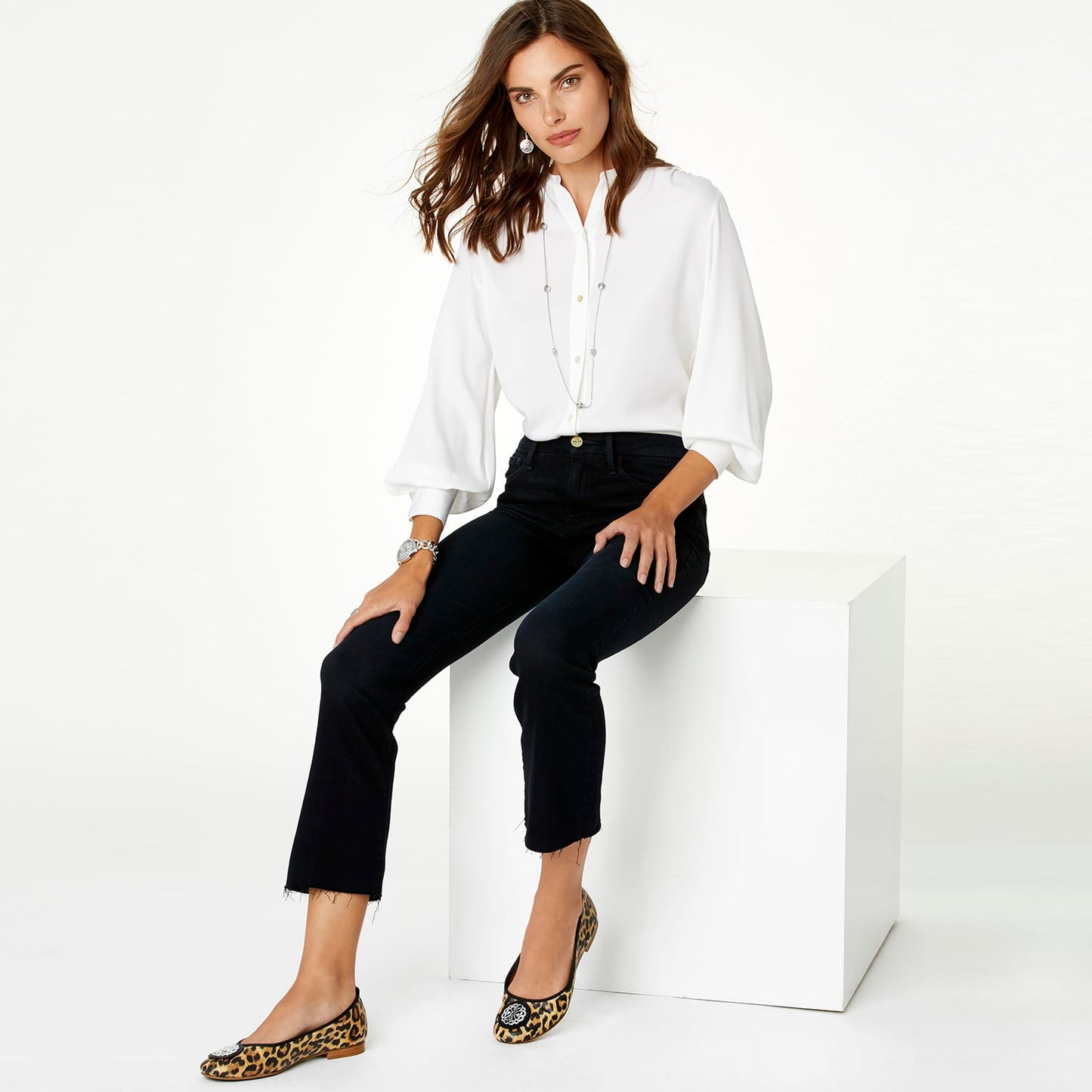 Model wearing a Brighton long silver-tone station necklace with crystal accents over a white blouse