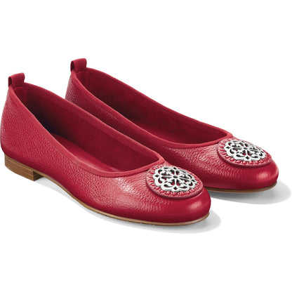 Brighton red leather ballet flats with silver-tone medallion accents and pebbled texture on a white background