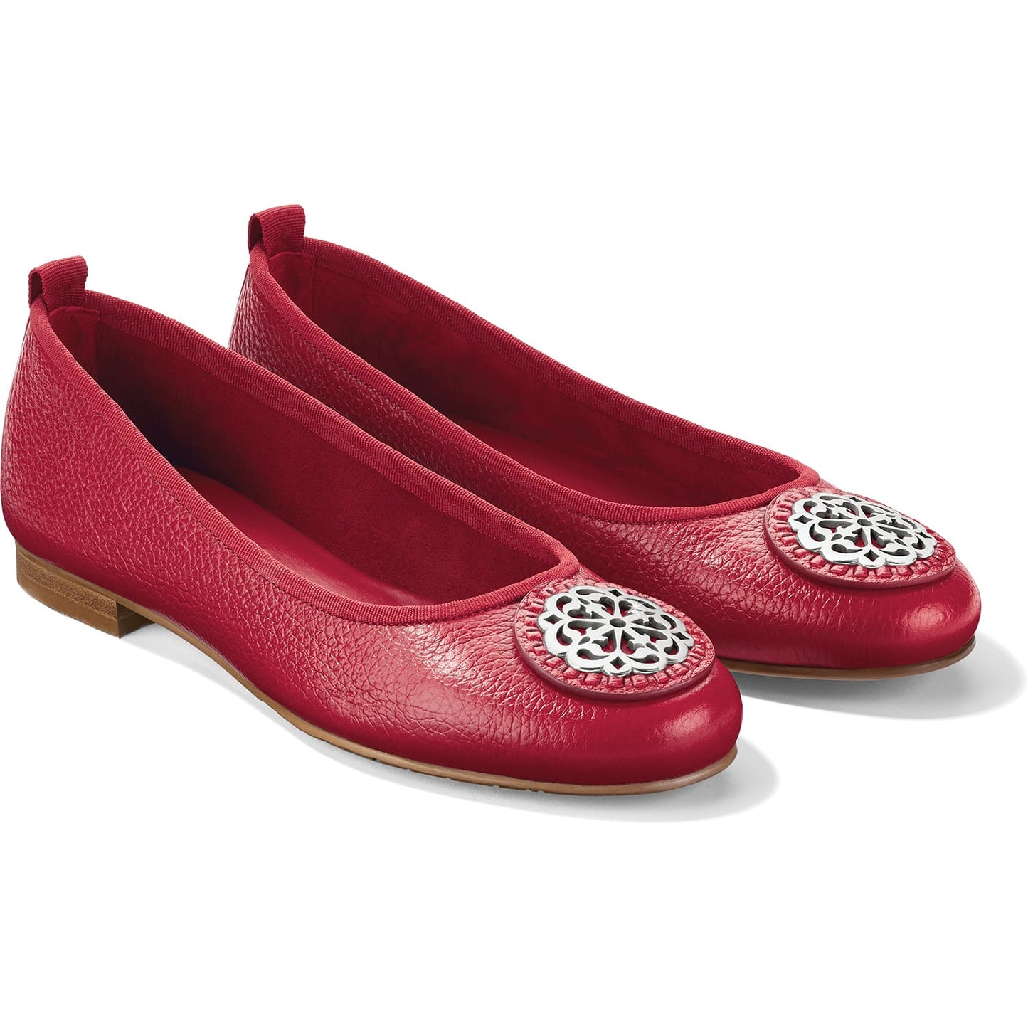 Brighton red leather ballet flats with silver-tone medallion accents and pebbled texture on a white background