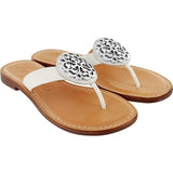 Brighton white thong sandals with ornate silver-tone medallion accents and tan leather footbeds on a white background