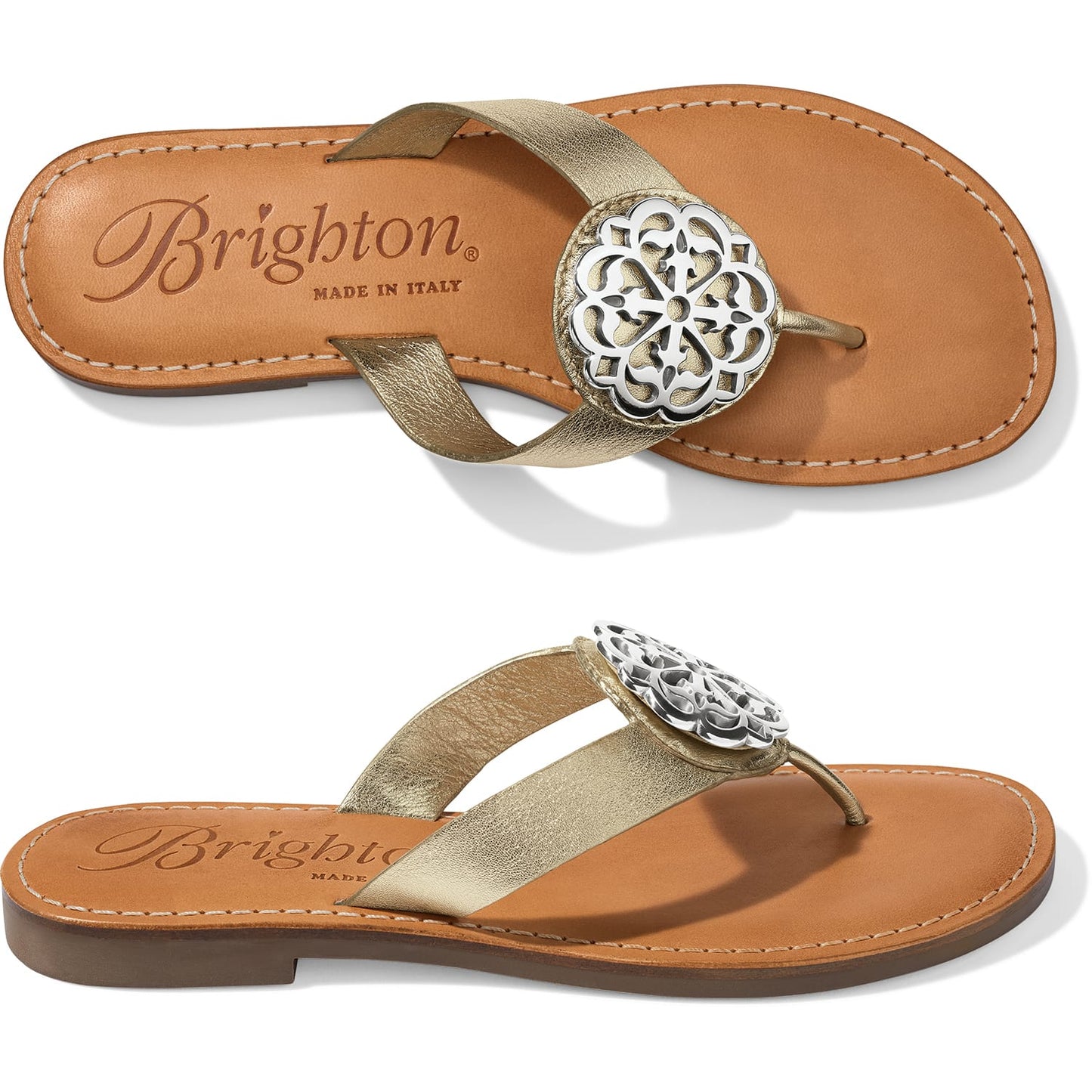 Brighton gold-tone leather thong sandals with silver-tone medallion ornament and tan footbed on a white background
