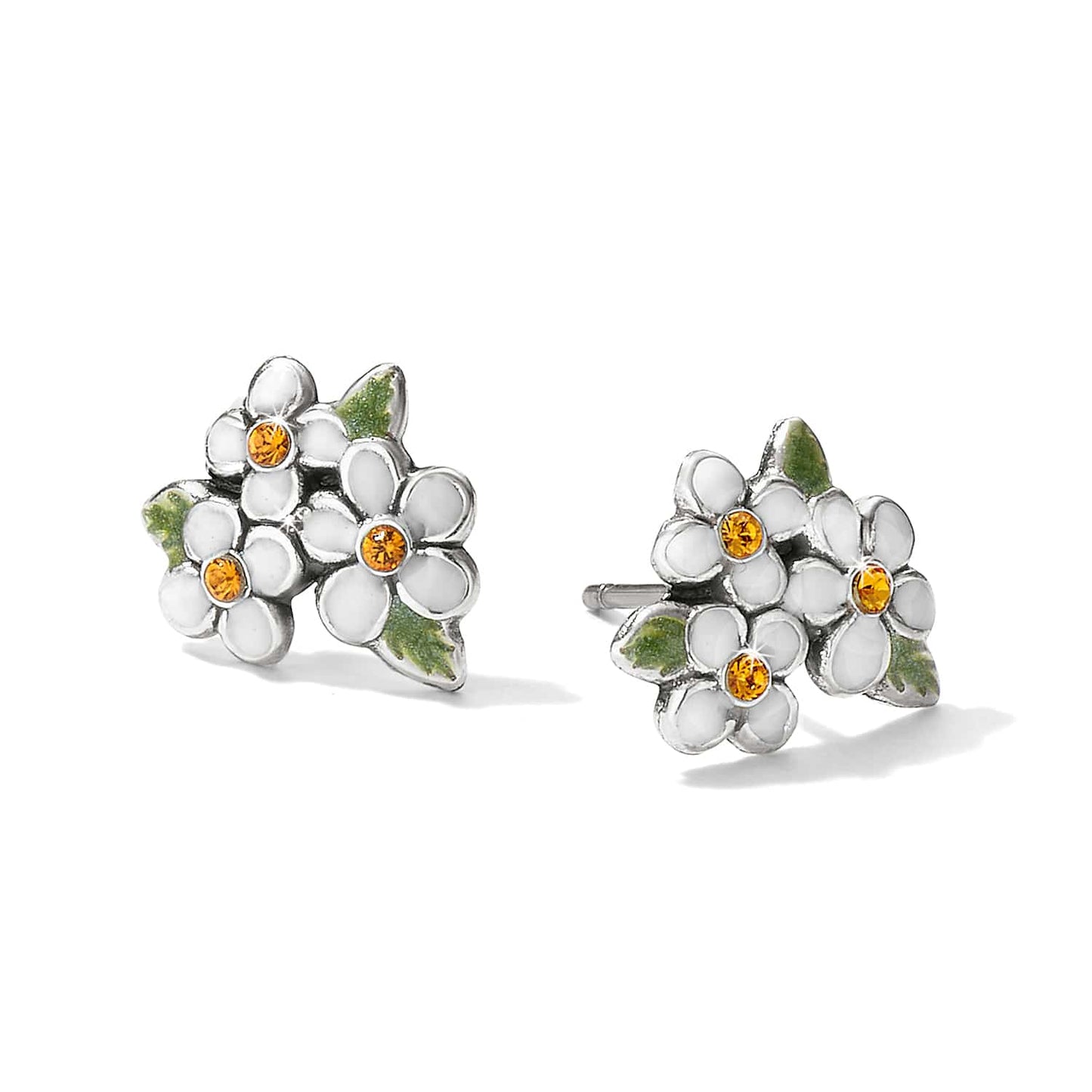 Brighton stud earrings with white enamel flowers, amber crystal centers, and green leaf accents on a white background