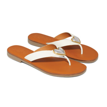 Brighton thong sandals in white leather with orange footbeds and silver-tone heart accents on a white background