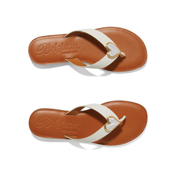 Brighton white leather thong sandals with gold-tone heart accent and tan footbed shown in pairs on a white background