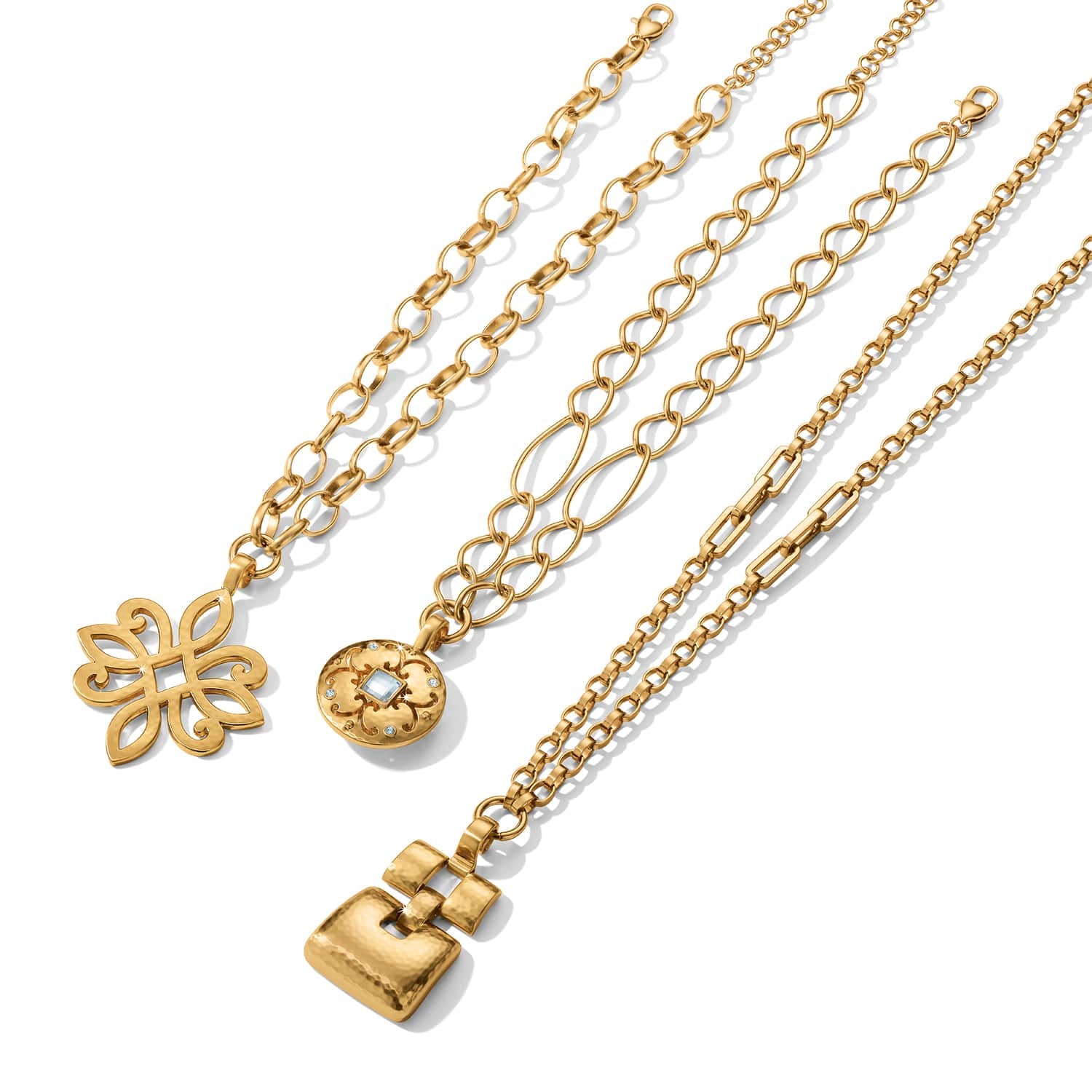 Brighton gold-tone necklaces with scroll pendant, round crystal medallion, and hammered square charm on a white background