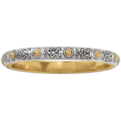 Brighton bangle bracelet with silver-plated scroll engravings, gold-plated bead accents, and gold-plated interior on a white background