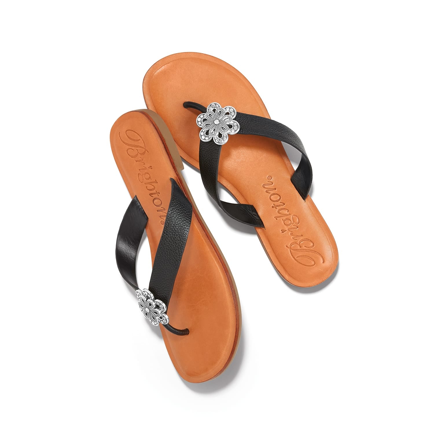 Brighton black leather thong sandals with silver-tone floral medallion accents and tan footbeds on a white background