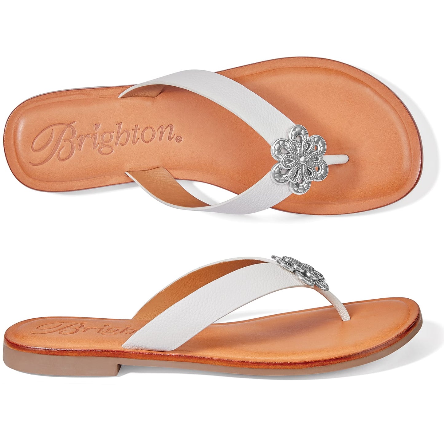 Brighton white leather thong sandals with silver-tone floral medallion accent and tan footbed on a white background