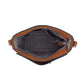 Close-up of Brighton handbag interior view showing brown leather trim, patterned fabric lining, and zippered pocket