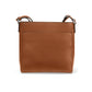 Brighton handbag shown from the back in tan pebbled leather with slim adjustable strap on a white background