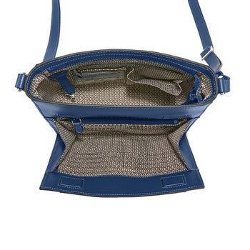 Brighton blue leather handbag shown open with patterned fabric interior, zip pocket, and adjustable strap on a white background