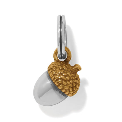 Brighton acorn charm with silver-tone body and gold-tone textured cap on a split ring on a white background