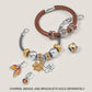 Brighton bracelets styled with silver-plated leaf charms and crystal beads in amber and red tones on neutral background
