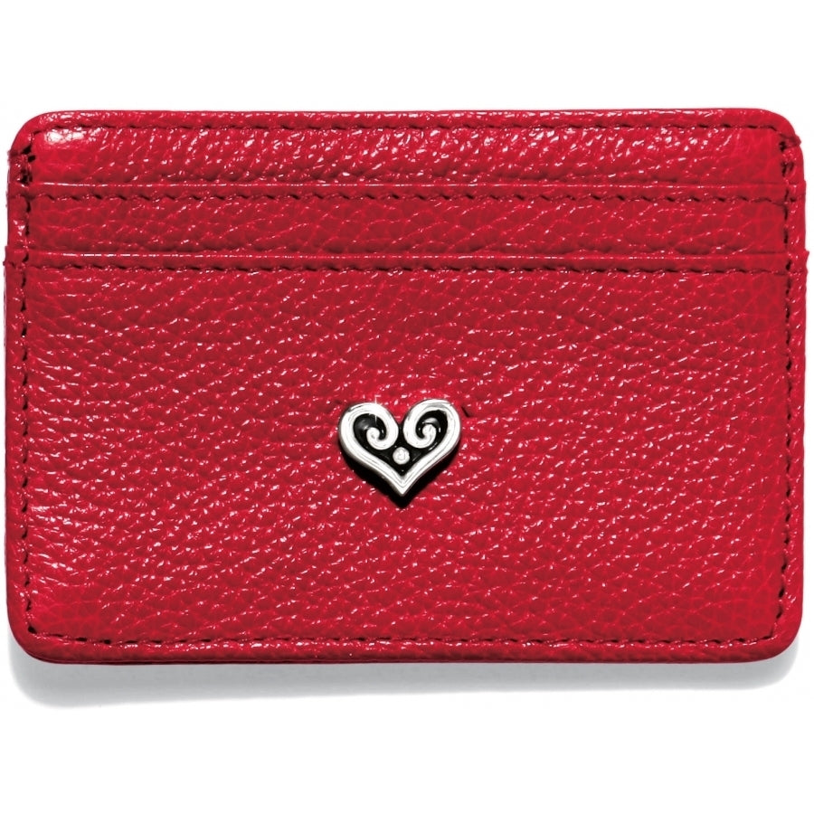Brighton red pebbled leather card case with silver-tone scrolled heart emblem at center on a white background