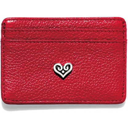 Brighton red pebbled leather card case with silver-tone scrolled heart emblem at center on a white background