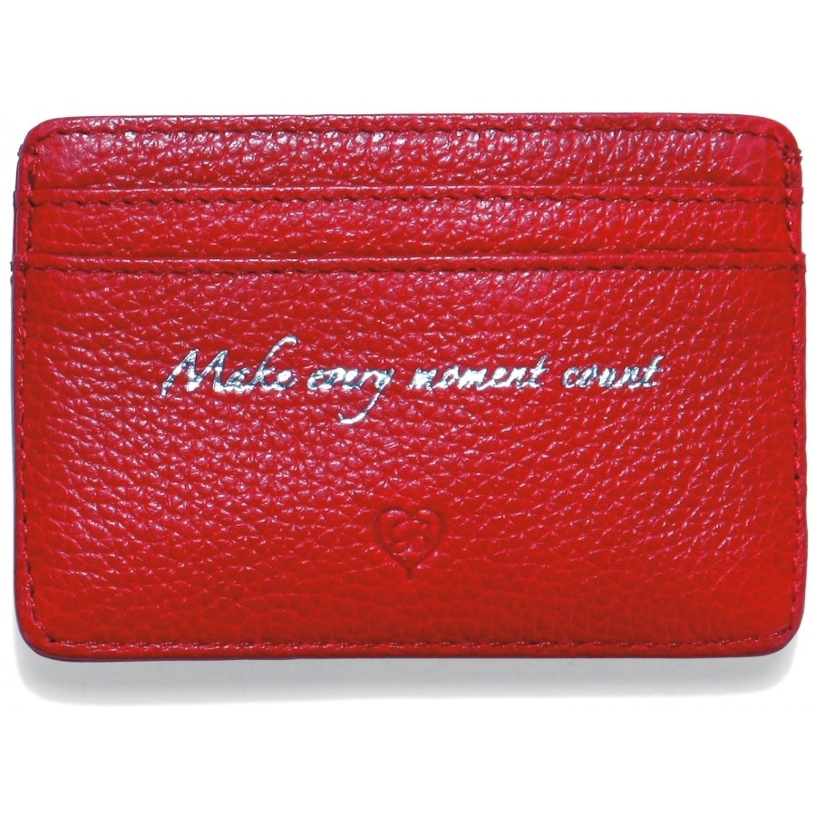 Brighton red pebbled leather card case with silver embossed script reading Make every moment count on a white background