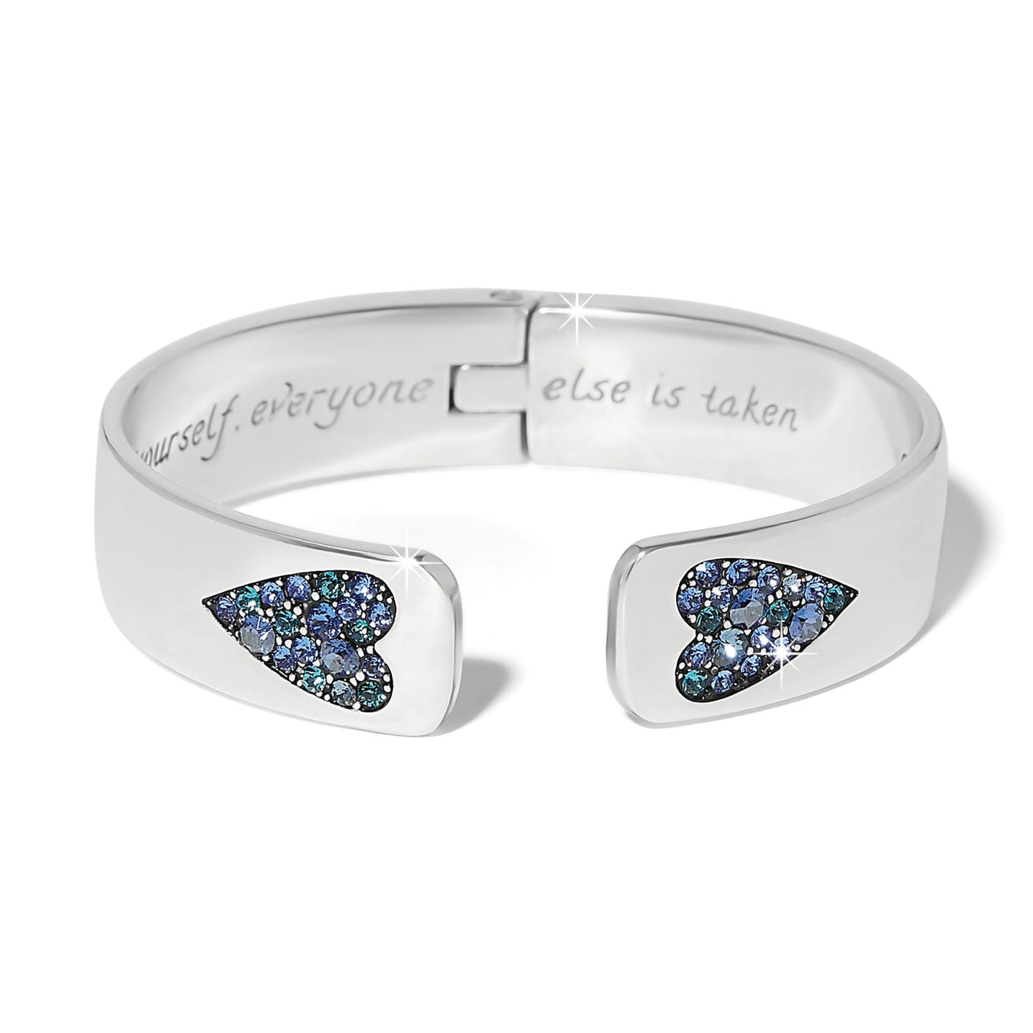 Brighton hinged cuff bracelet with silver-plated finish and blue crystal heart accents at open ends on a white background