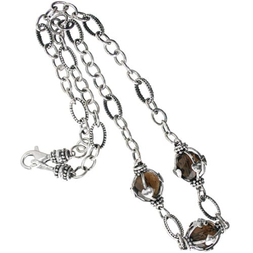 Brighton necklace with silver-tone chain, smoky brown faceted stones, and lobster clasp on a white background